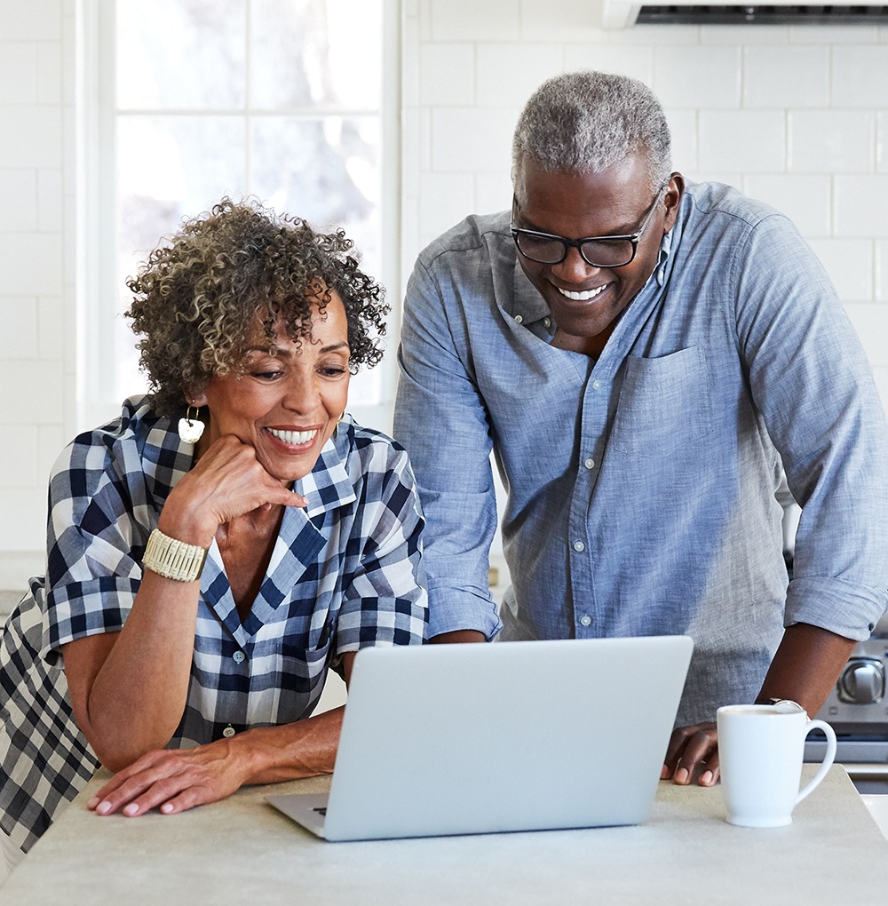 Senior African American on computer in the kitchen together
